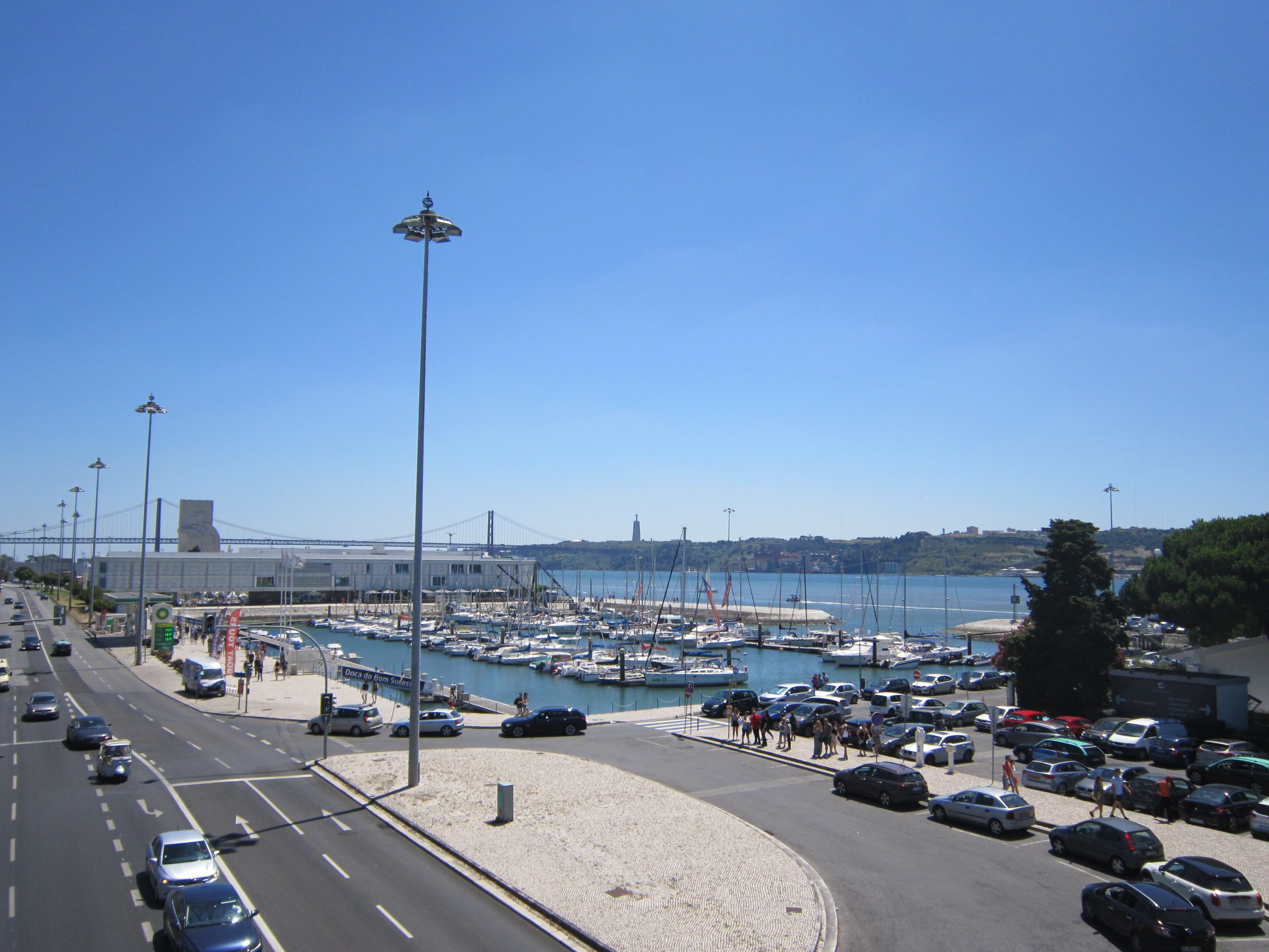 Lisbon waterfront marina and bridge on a bright summer day